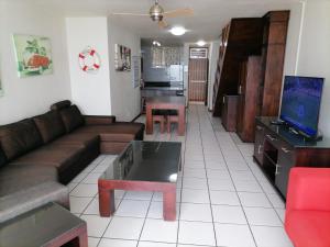 a living room with a couch and a table at Inyoni Rocks Cabanas 42 in Amanzimtoti