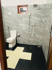 a bathroom with a shower and a toilet in it at Bliss Haven Transit Hotel in Negombo