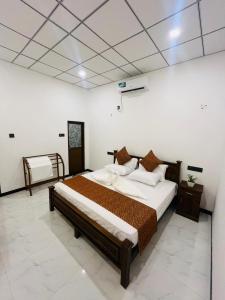 a bedroom with a large bed in a room at Bliss Haven Transit Hotel in Negombo +4 photos