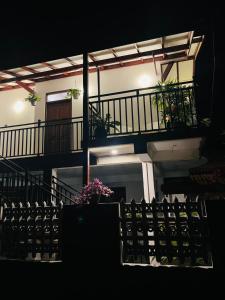 a building with a balcony with flowers on it at Bliss Haven Transit Hotel in Negombo