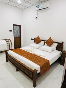 two large beds in a room with at Bliss Haven Transit Hotel in Negombo