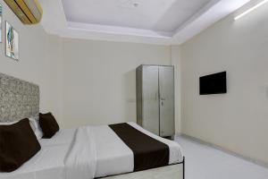 Ένα ή περισσότερα κρεβάτια σε δωμάτιο στο Hotel O M.C Residency +21 φωτογραφίες