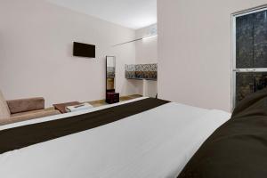 Ένα ή περισσότερα κρεβάτια σε δωμάτιο στο Hotel O by OYO Green Villa +22 φωτογραφίες