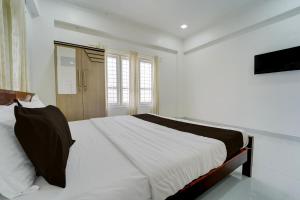 Postel nebo postele na pokoji v ubytování Collection O Kulathoor TechnoparkFormerly United Mansions + 28 fotografií