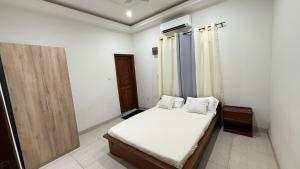 En eller flere senge i et værelse på La Maison des Palmiers