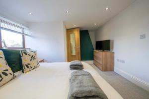 a bedroom with a large bed and a television at Stather Cottage in Burton upon Stather