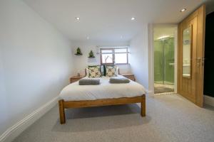 a bedroom with a bed with two pillows on it at Stather Cottage in Burton upon Stather