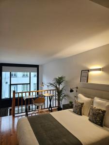 En eller flere senge i et værelse på Apartamentos Ciudad Santiago