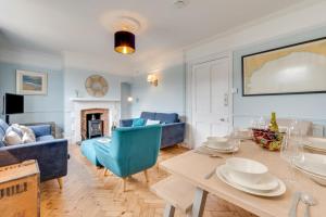 a living room with a table and blue chairs at 3 Bed in Beer oc-jb9wes in Beer