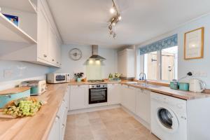 a kitchen with white cabinets and a dishwasher at 3 Bed in Beer oc-jb9wes in Beer