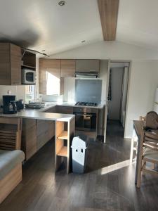 a kitchen with a counter and a table in it at GRS Mobil Home in Onzain