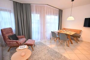 a living room with a dining room table and chairs at Ferienwohnung Nau in Oberstdorf