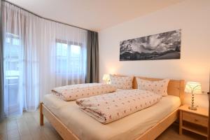 a bedroom with two beds and a window at Ferienwohnung Nau in Oberstdorf