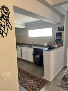 a kitchen with a counter and a sink and a window at Apartment in Elshatby in Alexandria +3 photos