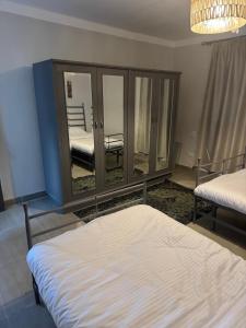 a bedroom with two beds and a mirror at Apartment in Elshatby in Alexandria