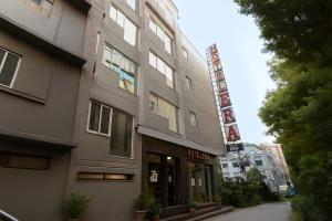 a building with a sign on the side of it at Hotel Era Premium Near Delhi Airport in New Delhi
