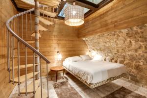 a bedroom with a bed and a staircase at Hôtel Marie in Paris
