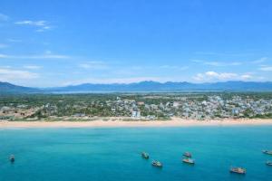 an aerial view of a beach with boats in the water at HiDra Homestay in An Tịnh