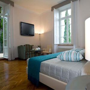 a bedroom with a bed and a television on the wall at Relais Villa Sant'Isidoro in Colbuccaro