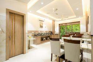 a kitchen and dining room with a table and chairs at Hotel Era Premium Near Delhi Airport in New Delhi