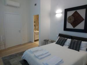 a bedroom with a bed with two towels on it at Opera 19 Luxury Apartment in Florence