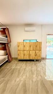 an empty room with wooden chests in a room at Romny cozy bay Resort in Koh Rong Sanloem