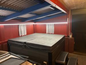 a bed in a room with red walls at Ferienhaus Spielburg in Altötting