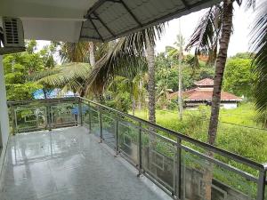 a balcony with a view of a house at Somatheertham Resort in Kovalam