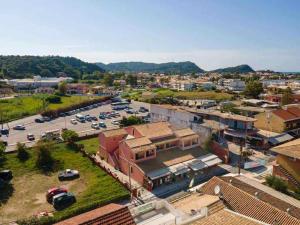 an aerial view of a town with a parking lot at Exclusive Alexandra Apartments in Sidari +8 photos