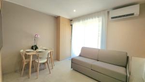 a living room with a couch and a table at Studio du Soleil in Le Val