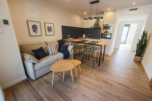 een woonkamer met een bank en een keuken bij Apartamentos PRAIA DO CANSORRO in Camariñas