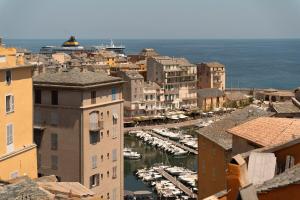 a view of a city with boats in a harbor at Vatta appartement centre ville avec roof top bain à remous et vue panoramique in Bastia