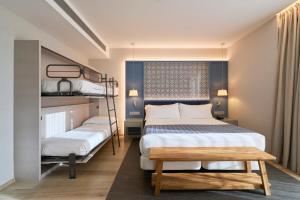 a bedroom with two bunk beds and a table at Catalonia Porto in Porto +45 photos