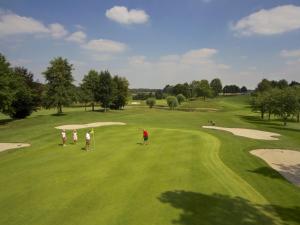 a group of people playing golf on a golf course at SEPHS Hotel Sittard in Sittard