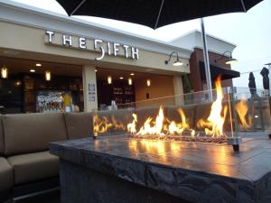 a fire pit in front of a store with flames at Grand Legacy At The Park in Anaheim