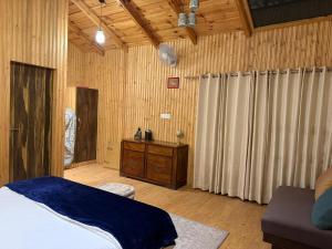 a bedroom with a bed and a wooden ceiling at The Hilltop Hideaway in Mukteshwar