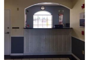 an empty waiting room with a counter and a window at Motel 6-Tyler, TX in Tyler