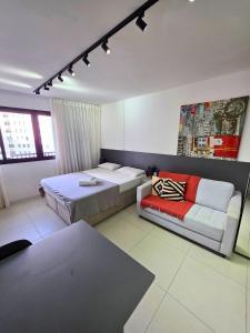a hotel room with two beds and a couch at Estúdio sofisticado no centro do Rio com vaga de garagem in Rio de Janeiro +24 photos