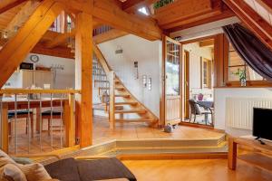 a living room with a staircase in a house at Haldenmichelhof Ferienwohnungen in Breitnau