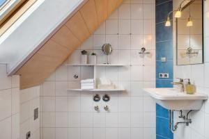 a bathroom with a sink and a staircase at Haldenmichelhof Ferienwohnungen in Breitnau +155 photos