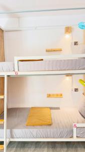 a bunk bed in a dorm room with a yellow blanket at Romny cozy bay Resort in Koh Rong Sanloem