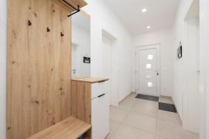 a kitchen with white walls and a wooden door at Apartments Latkovic in Zaostrog +151 photos
