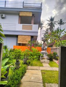 a house with a garden in front of it at Dharma Yoga Guest House Amed in Amed