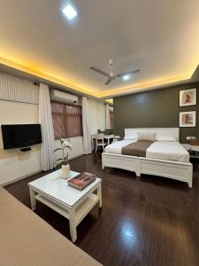 a bedroom with a bed and a living room at The Ketan in Pune +15 photos