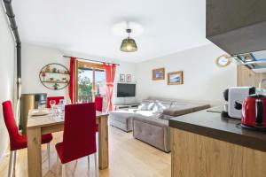 a kitchen and living room with a couch and a table at Hostdomus - La Chapelle in Sauze d'Oulx