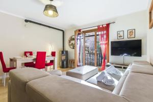 a living room with a couch and a table at Hostdomus - La Chapelle in Sauze d'Oulx