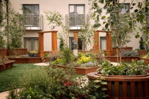 a garden in front of a building with plants at Westport Plaza Hotel, Spa & Leisure in Westport