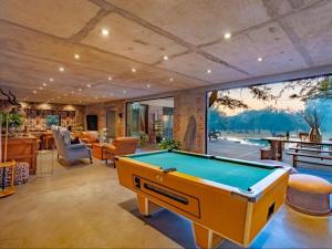 a living room with a pool table in it at Dombeya Private Game Reserve in Vaalwater