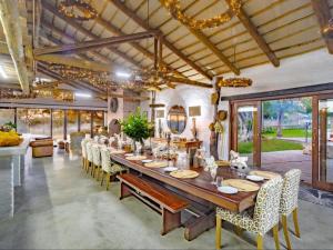 a large dining room with a long table and chairs at Dombeya Private Game Reserve in Vaalwater