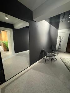 een woonkamer met een stoel en een spiegel bij LVO Apartments in Bîrlad